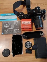 Vintage Canon A-1 Camera Lot With Nikura Lens, Bag, Strap, And Filters Untested