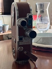 Working Keystone A-12 16mm movie camera with lenses and camera case.